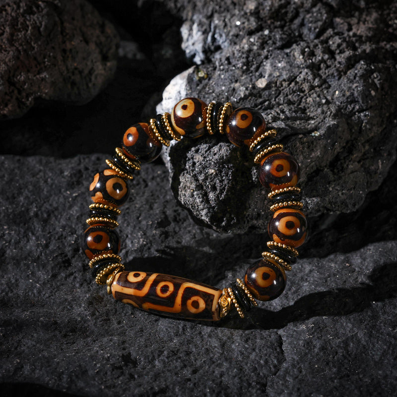 Bracciale tibetano con perline Dzi e simbolo Om.